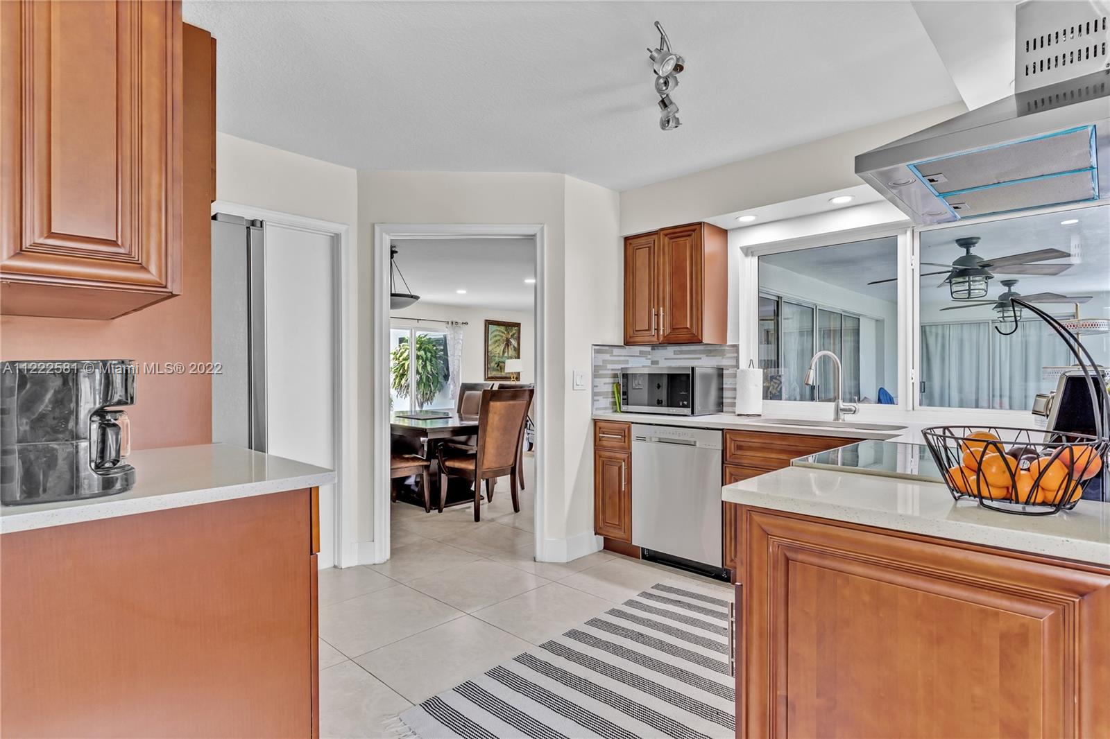 10820 Eureka Street Boca Raton, FL 33428 - Photo 28 of 39 a kitchen with a refrigerator and a sink