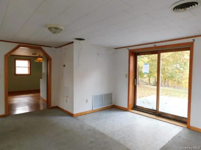 a view of room with window and wooden floor