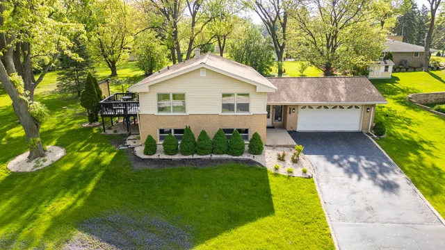 a view of a house with a yard and a garden