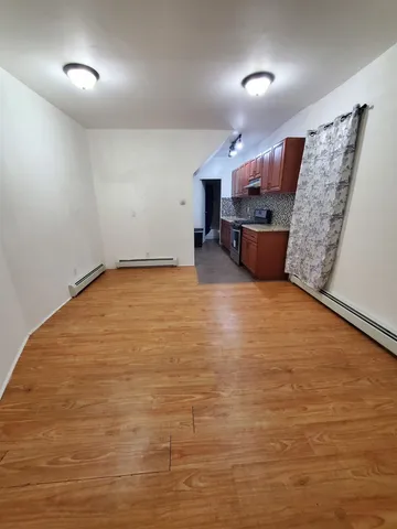 a view of a room with wooden floor