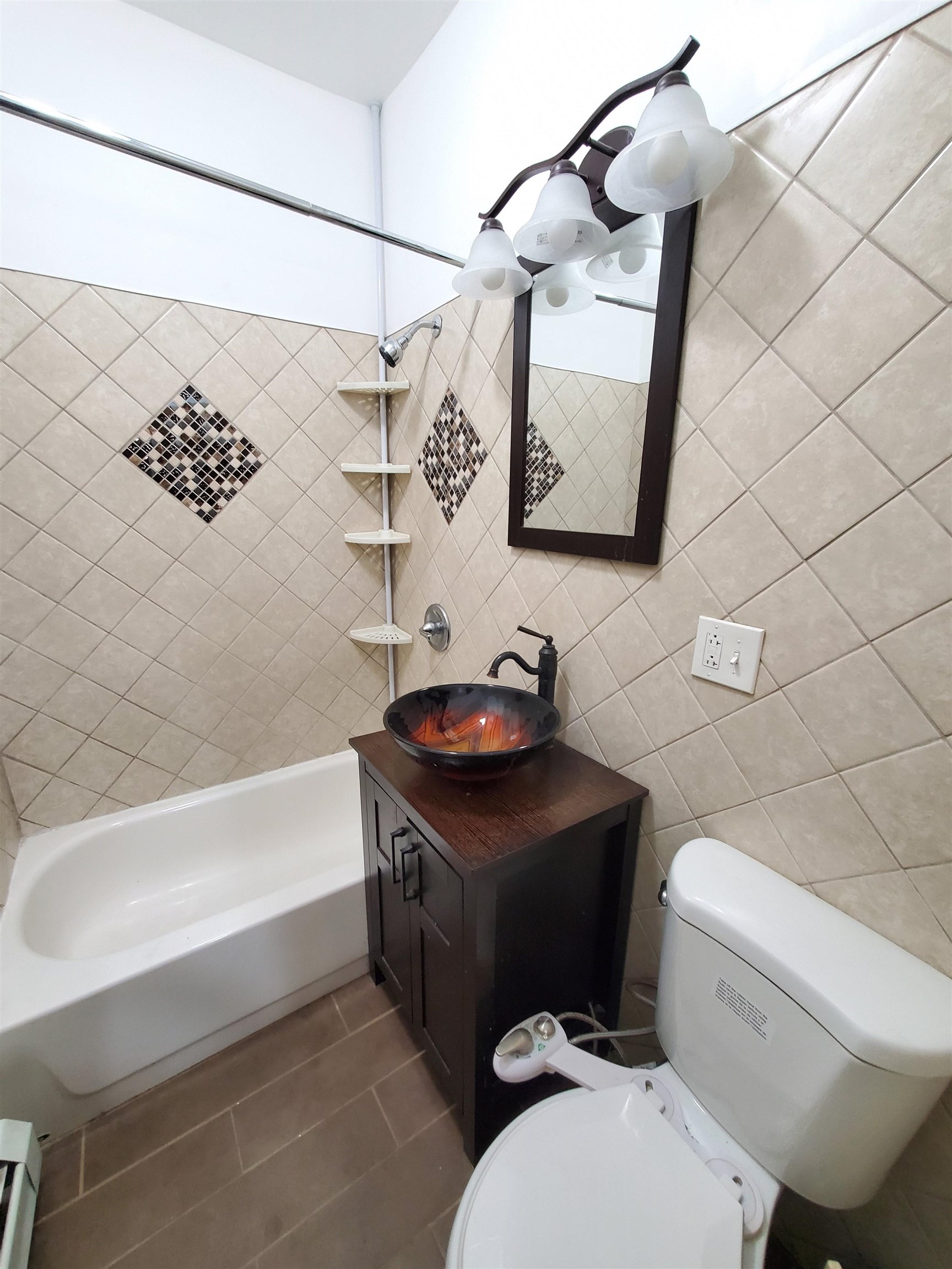 140 West 3rd Street, Unit 1 Bayonne, NJ 07002 - Photo 3 of 8 a bathroom with a sink a toilet and bathtub