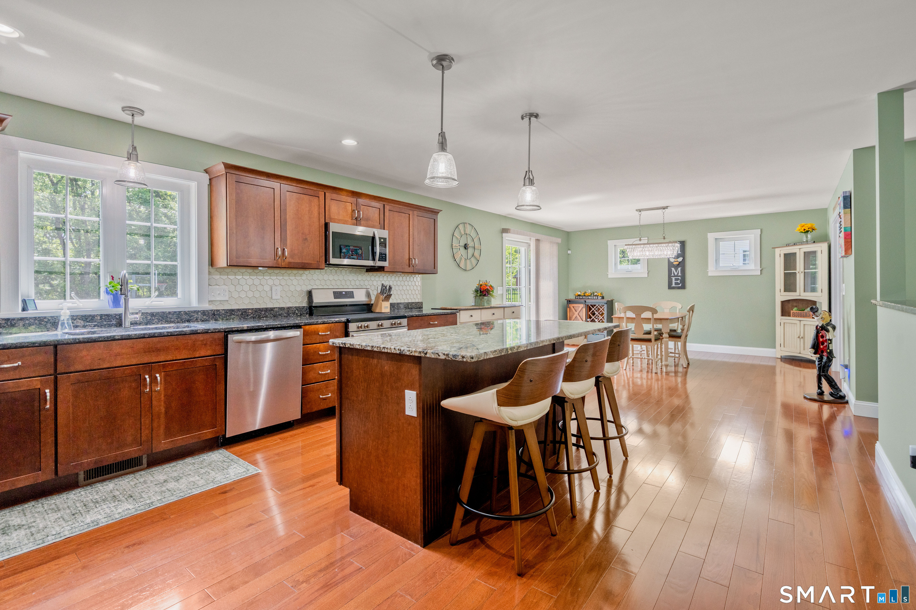 5 Limric Lane Suffield, CT 06078 - Photo 6 of 36 a kitchen with stainless steel appliances granite countertop wooden cabinets a dining table and chairs