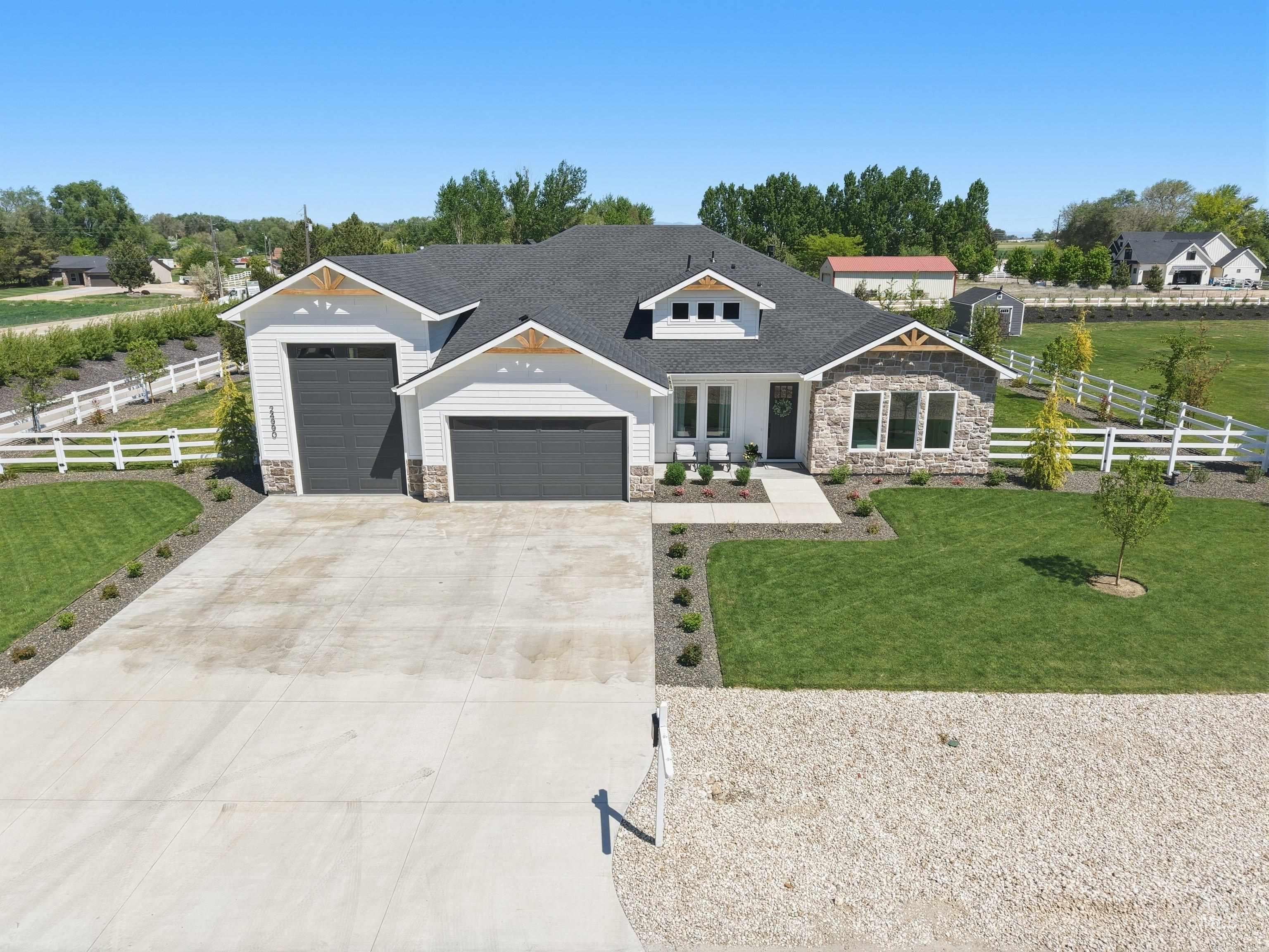 24990 Belgian Way Middleton, ID 83644 - Photo 44 of 50 Modern farmhouse exterior featuring white siding and stone accents