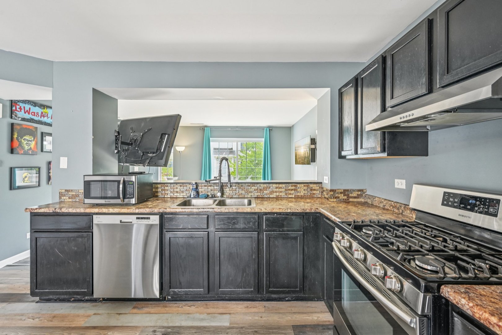 47 South Treehouse Lane Round Lake, IL 60073 - Photo 7 of 23 a kitchen with stainless steel appliances granite countertop a sink stove and cabinets