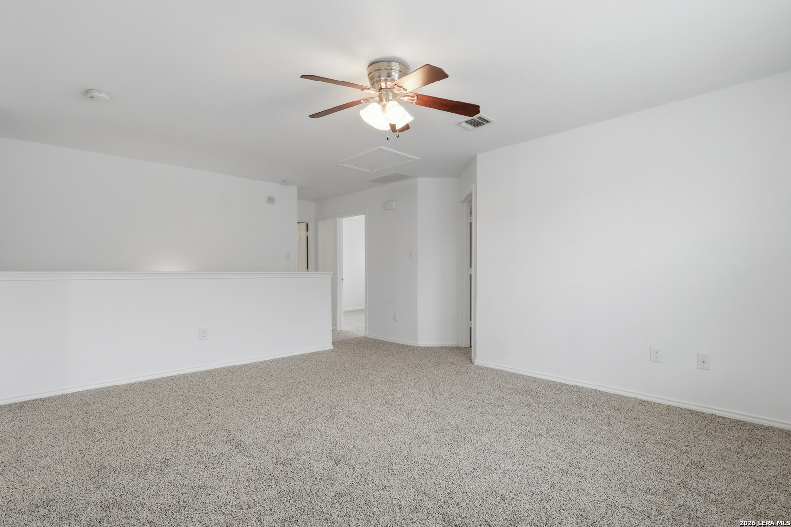 9819 Hawk Shore Converse, TX 78109 - Photo 11 of 26 a view of an empty room with a chandelier fan