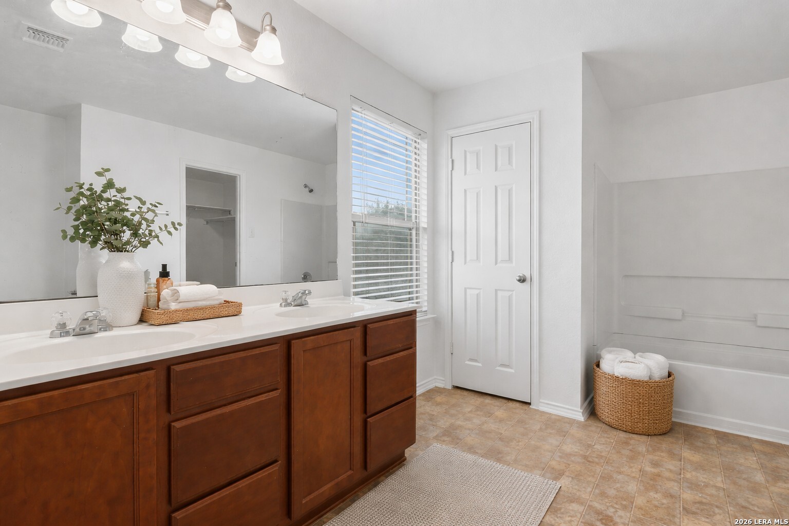 9819 Hawk Shore Converse, TX 78109 - Photo 14 of 26 a bathroom with a tub a sink and mirror