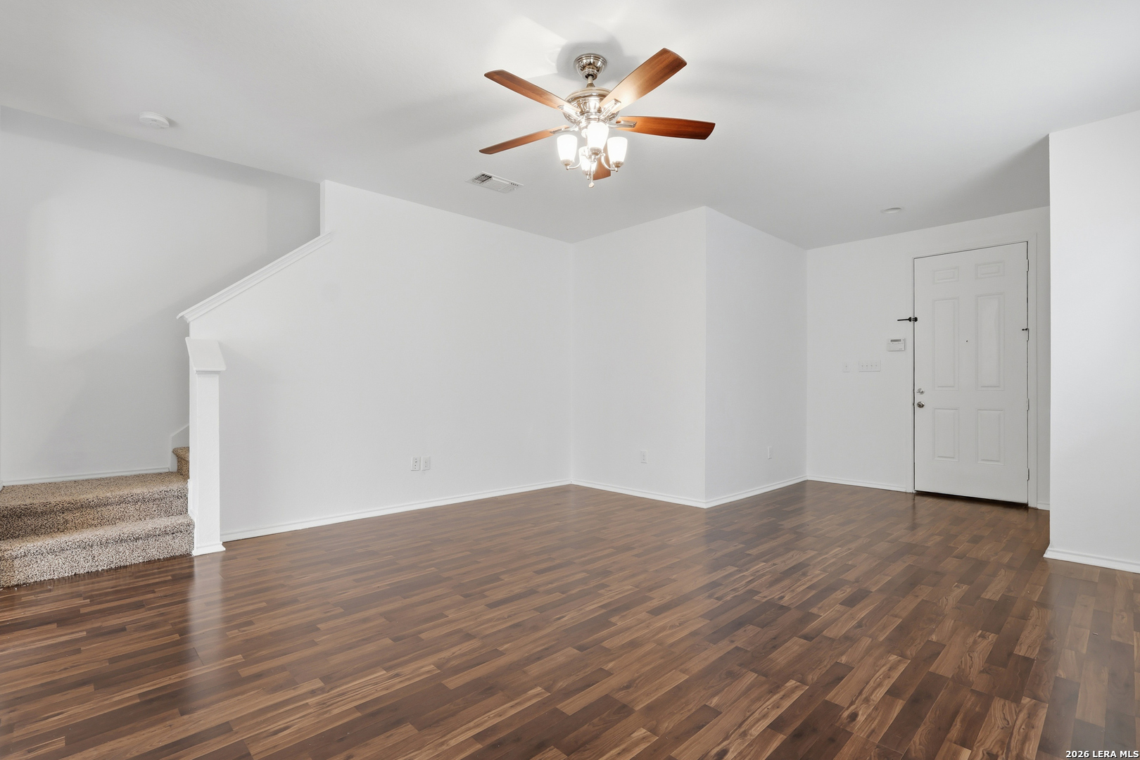 9819 Hawk Shore Converse, TX 78109 - Photo 4 of 26 an empty room with wooden floor and ceiling fan