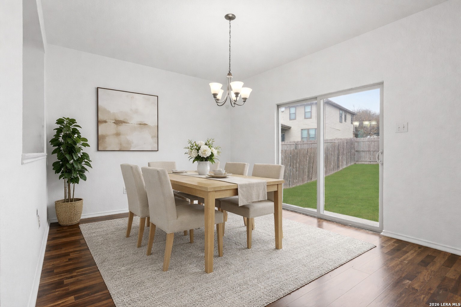 9819 Hawk Shore Converse, TX 78109 - Photo 5 of 26 a dining room with furniture potted plants and wooden floor