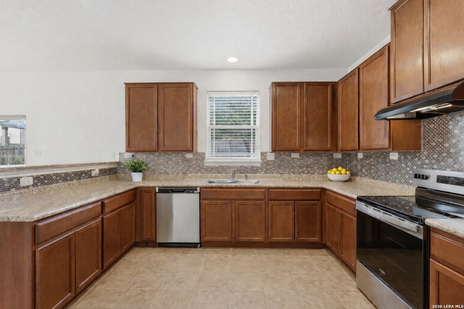 9819 Hawk Shore Converse, TX 78109 - Photo 8 of 26 a kitchen with stainless steel appliances granite countertop a sink stove and cabinets