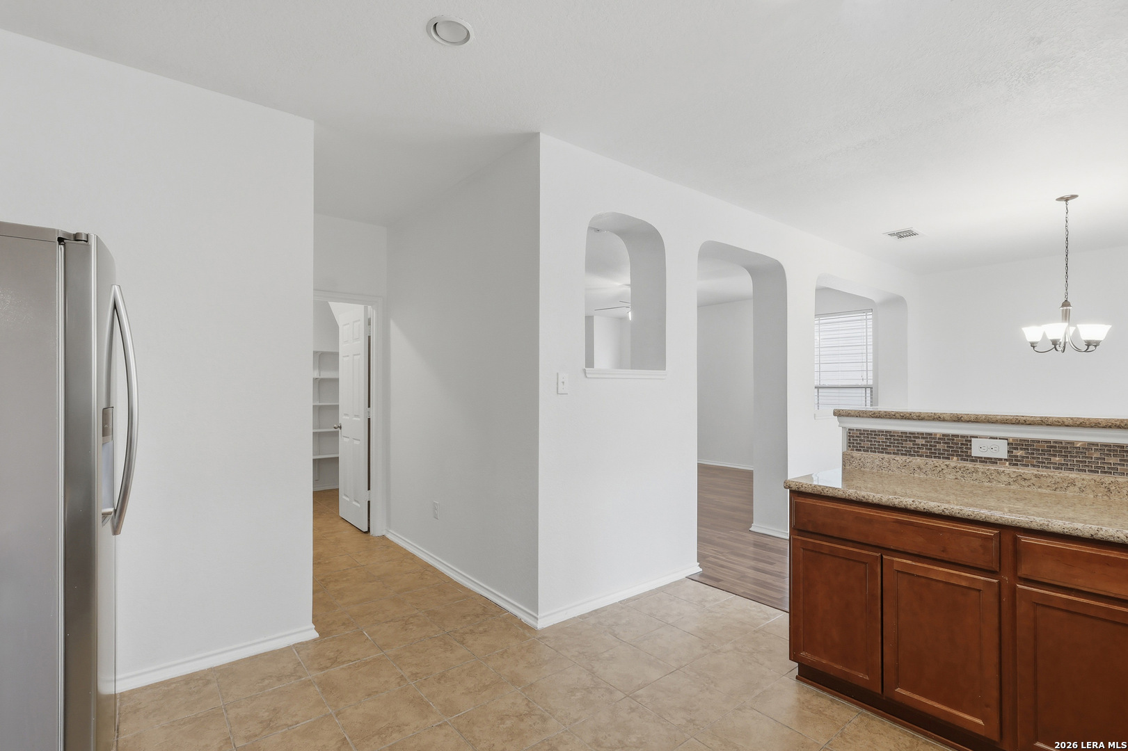 9819 Hawk Shore Converse, TX 78109 - Photo 9 of 26 a view of a kitchen with cabinets and wooden floor