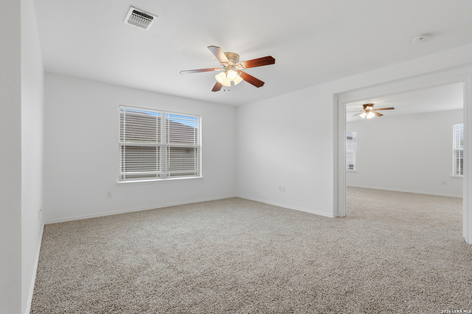 9819 Hawk Shore Converse, TX 78109 - Photo 10 of 26 an empty room with windows and fan