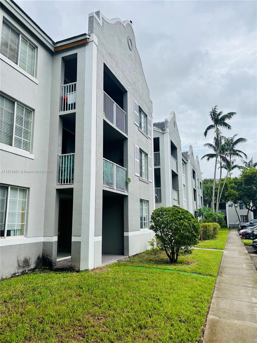 777 Southwest 111th Way, Unit 101 Pembroke Pines, FL 33025 - Photo 3 of 7 a house view with a garden space