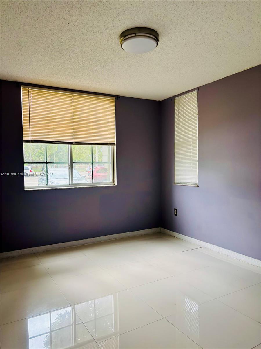 777 Southwest 111th Way, Unit 101 Pembroke Pines, FL 33025 - Photo 7 of 7 an empty room with windows