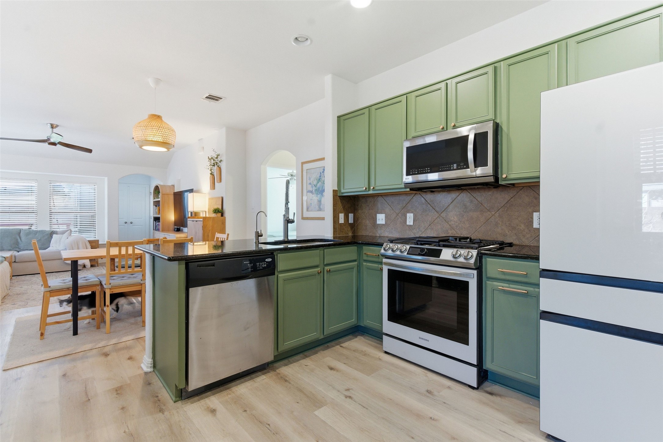 2513 Winchell Lane Austin, TX 78725 - Photo 22 of 23 a kitchen with stainless steel appliances a stove microwave and sink