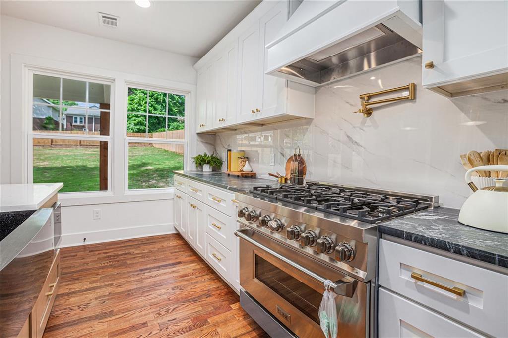 1721 South Gordon Street Southwest Atlanta, GA 30310 - Photo 18 of 44 a kitchen with stainless steel appliances granite countertop a stove and a sink