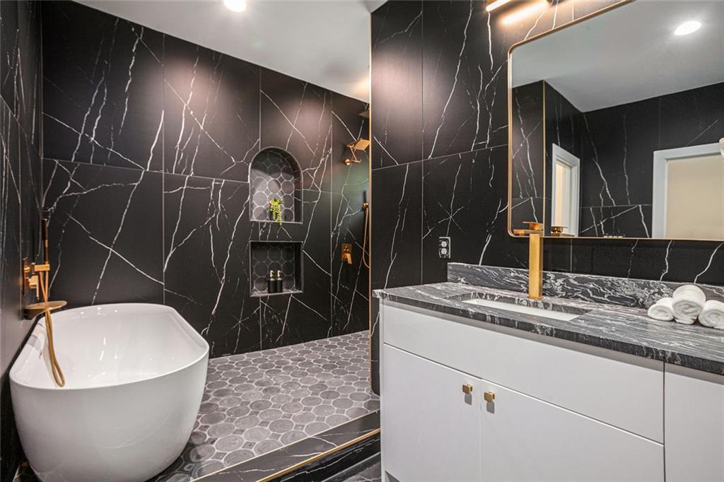 1721 South Gordon Street Southwest Atlanta, GA 30310 - Photo 27 of 44 a bathroom with a granite countertop sink a toilet and mirror