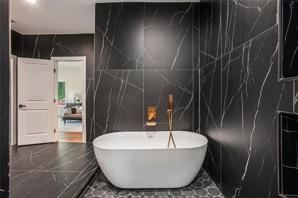 1721 South Gordon Street Southwest Atlanta, GA 30310 - Photo 28 of 44 a bathroom with a bathtub and shower