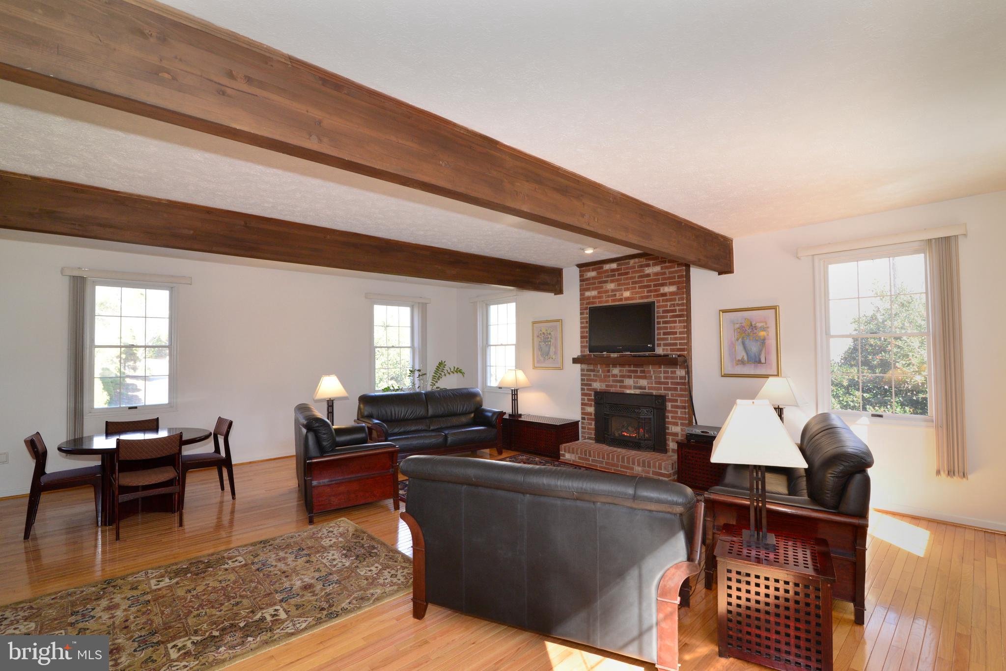 1966 Barton Hill Road Reston, VA 20191 - Photo 33 of 52 a living room with furniture a fireplace a flat screen tv and windows