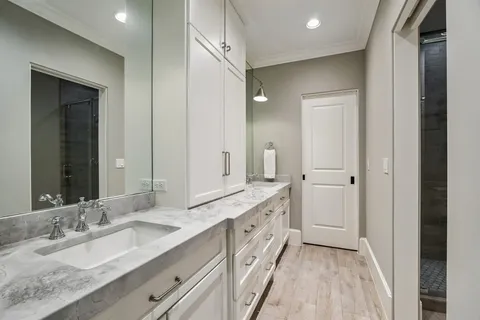 a bathroom with a double vanity sink and a mirror