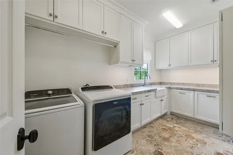 a utility room with sink dryer and washer