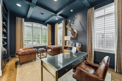 a living room with furniture and large windows