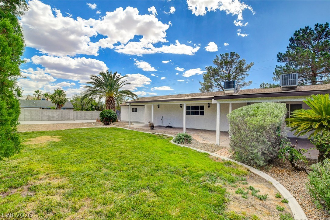 1810 Pinto Road Henderson, NV 89002 - Photo 46 of 53 A spacious backyard with a generous lawn and a covered patio for outdoor enjoyment.