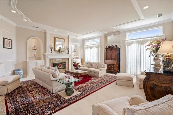 a living room with furniture fireplace and a large window