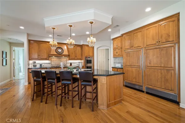 a kitchen with stainless steel appliances granite countertop a stove and a sink with cabinets