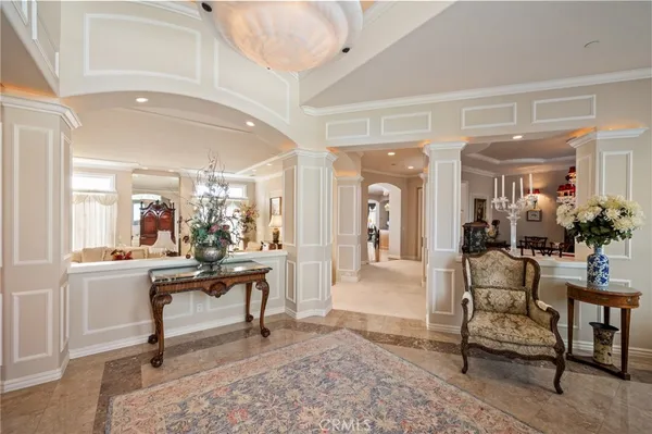 a living room with furniture a dining table and a large window