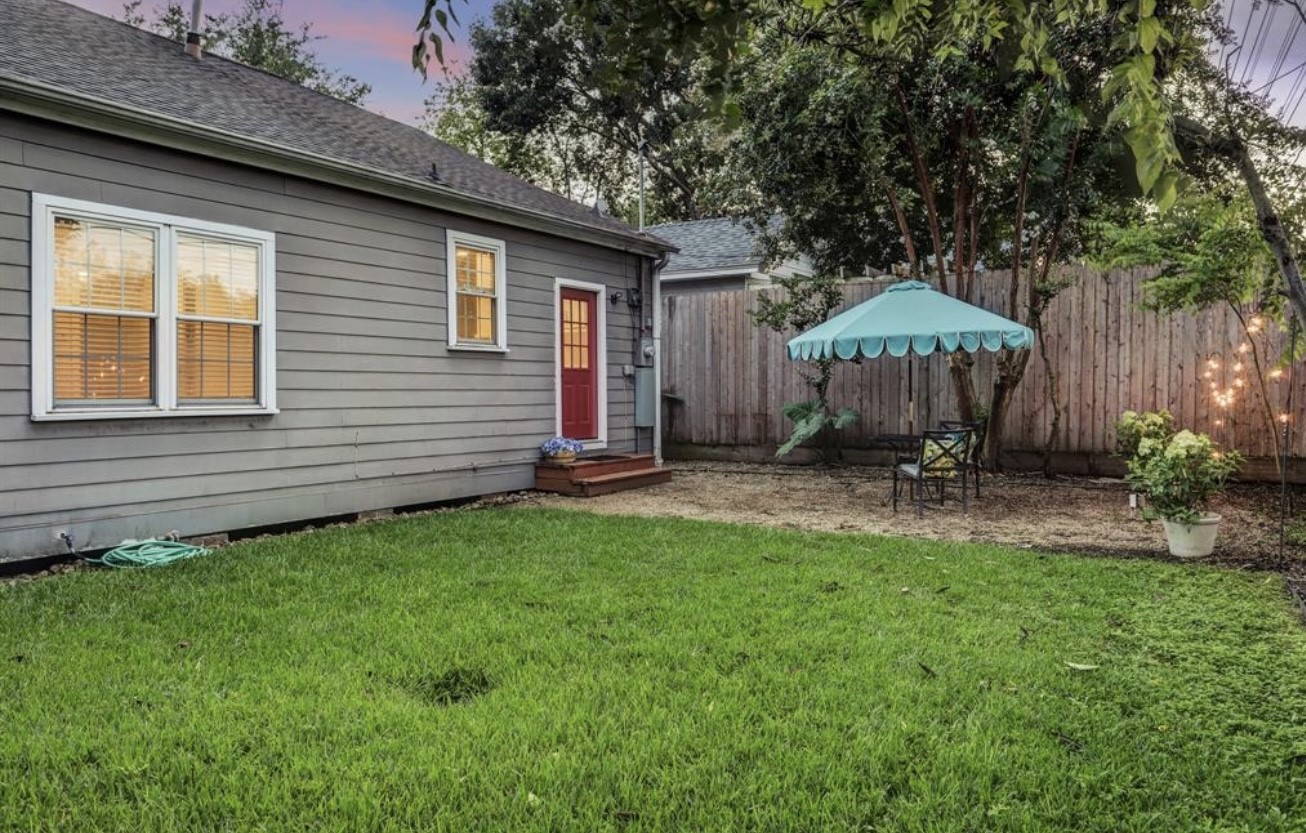 1624 Vassar Street Houston, TX 77006 - Photo 11 of 11 a view of a backyard with table and chairs under an umbrella