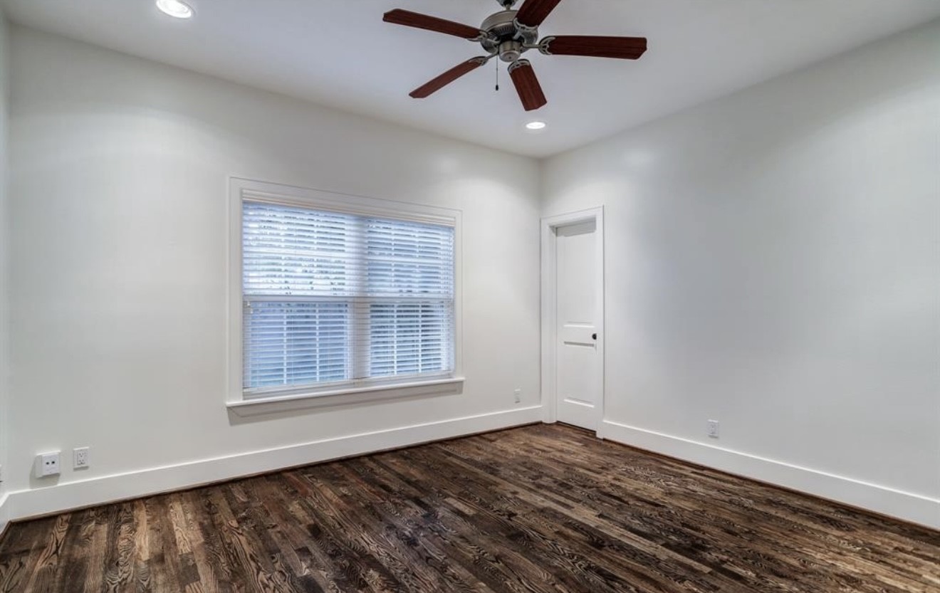 1624 Vassar Street Houston, TX 77006 - Photo 3 of 11 wooden floor in an empty room with a window
