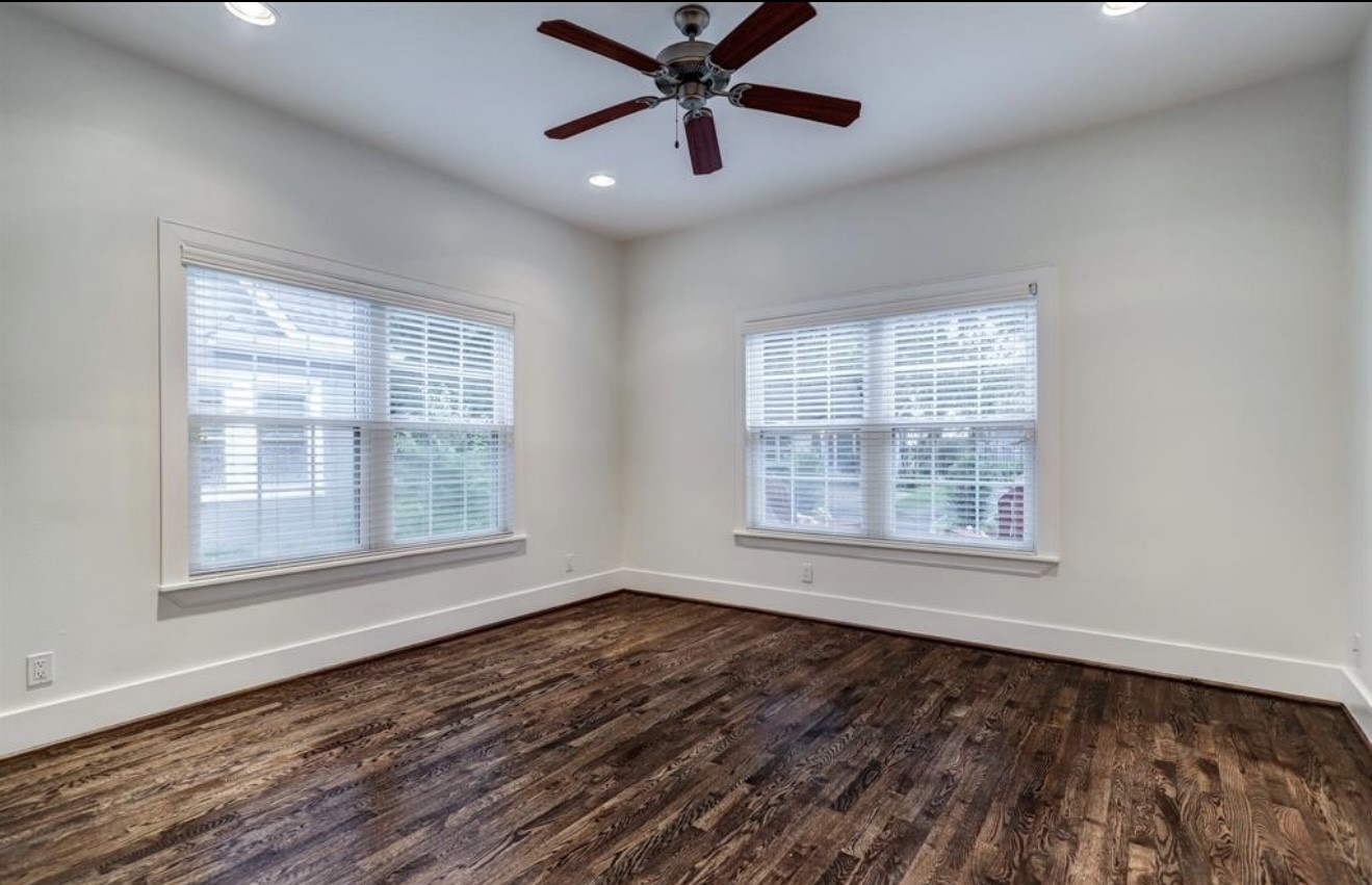 1624 Vassar Street Houston, TX 77006 - Photo 5 of 11 an empty room with wooden floor windows and fan