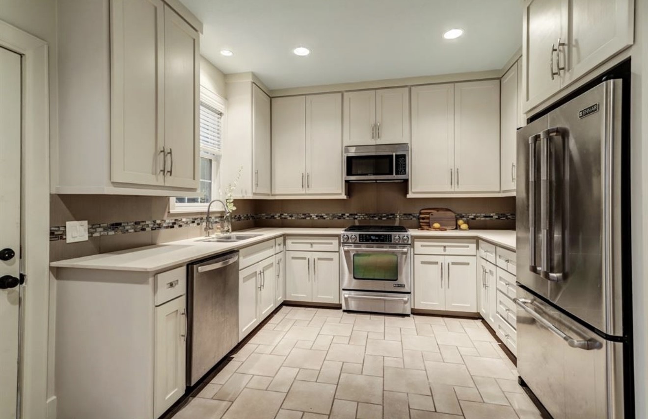 1624 Vassar Street Houston, TX 77006 - Photo 6 of 11 a kitchen with a sink stove and refrigerator