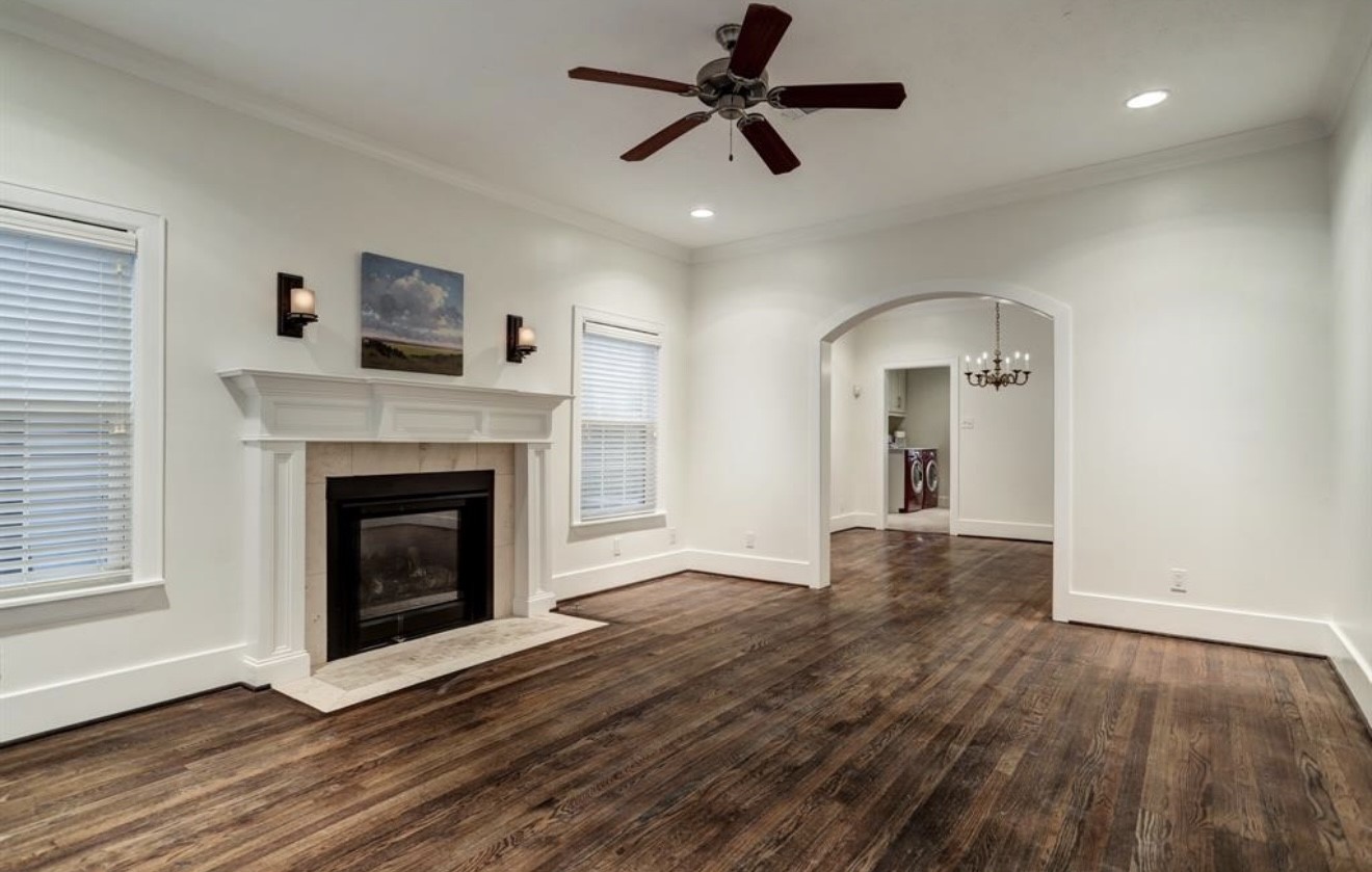 1624 Vassar Street Houston, TX 77006 - Photo 9 of 11 a view of a livingroom with a fireplace a ceiling fan and wooden floor