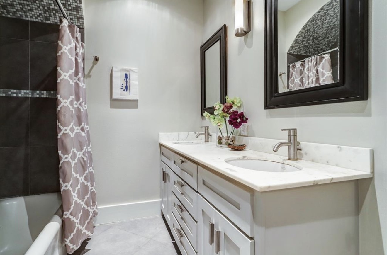 1624 Vassar Street Houston, TX 77006 - Photo 10 of 11 a bathroom with a sink and a mirror