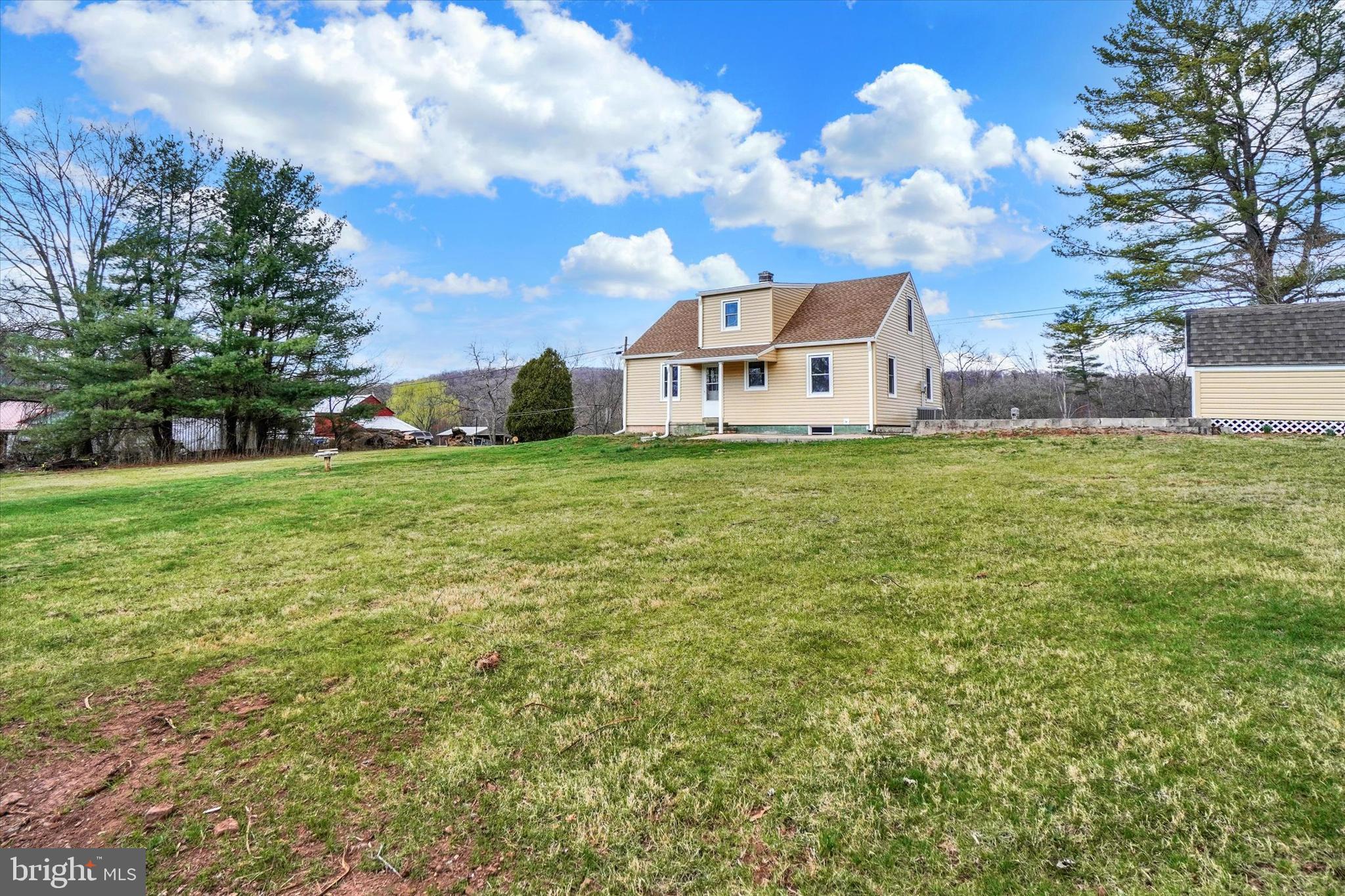 1050 Buck Road Dover, PA 17315 - Photo 23 of 28 a view of a house with a big yard and large trees