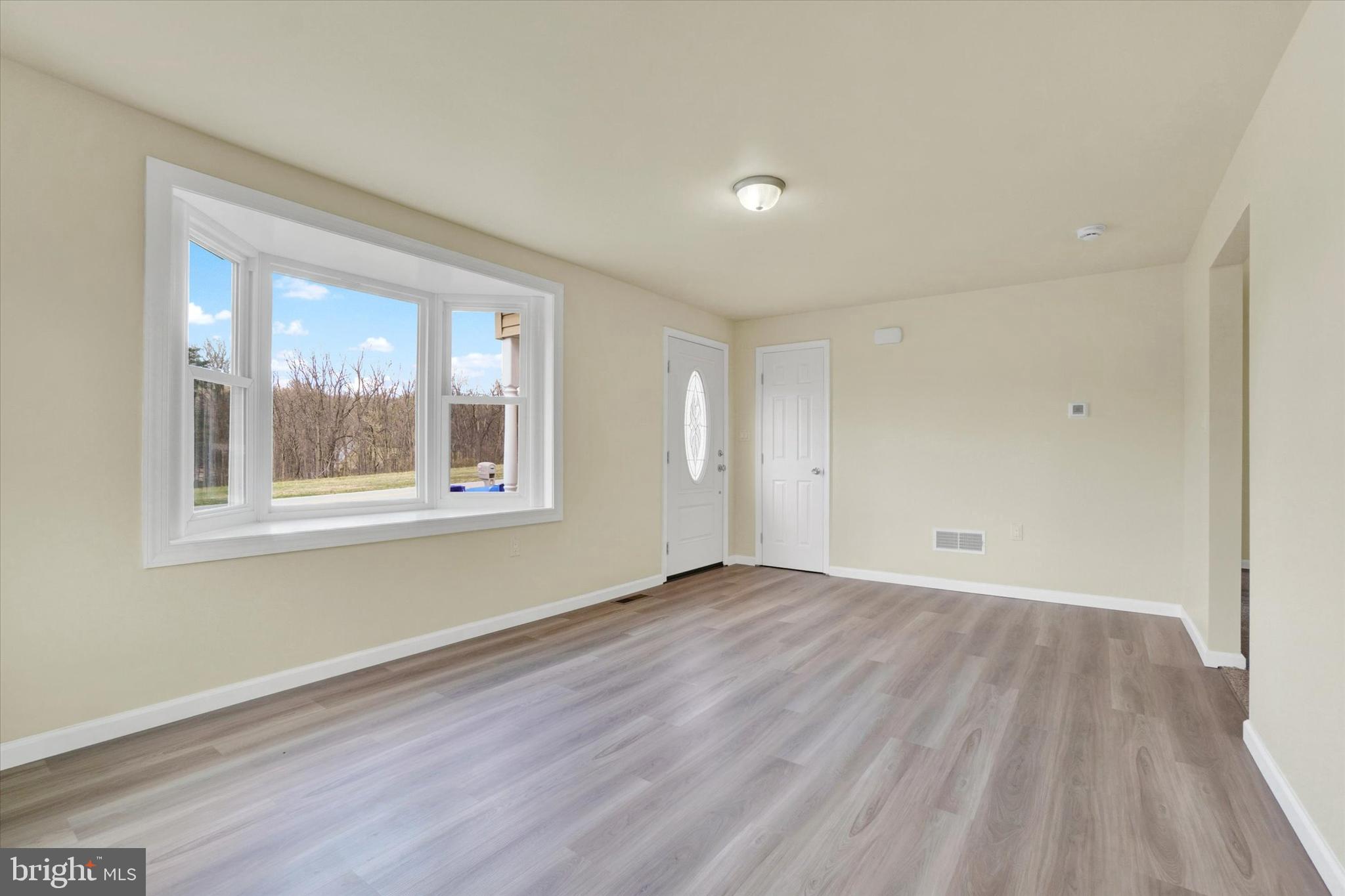 1050 Buck Road Dover, PA 17315 - Photo 3 of 28 a view of an empty room with wooden floor and a window