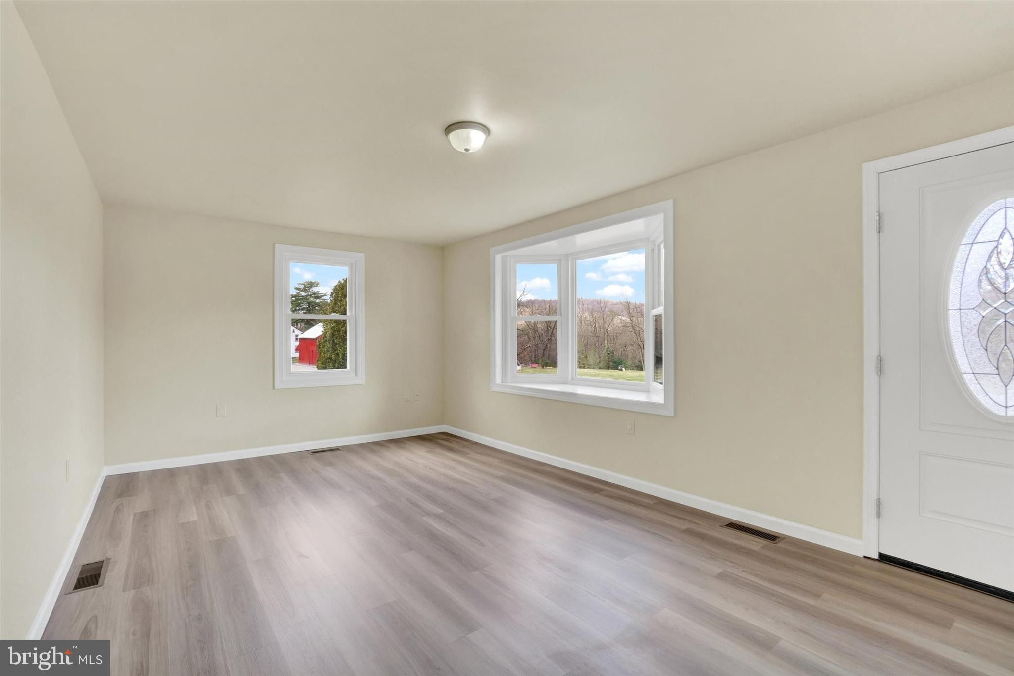 1050 Buck Road Dover, PA 17315 - Photo 4 of 28 an empty room with wooden floor and windows