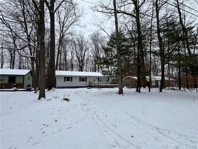 a view of a house with a snow in the yard
