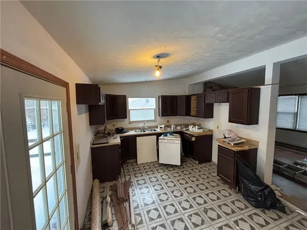 a kitchen with a sink stove and refrigerator
