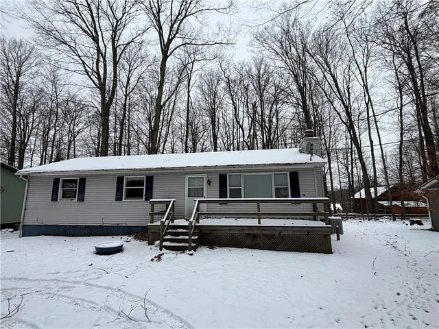 a view of a house with a yard covered in snow