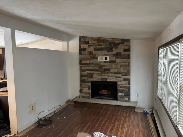 a room with fireplace and wooden floor