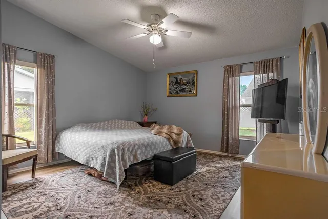 a bed sitting in a bedroom next to a window