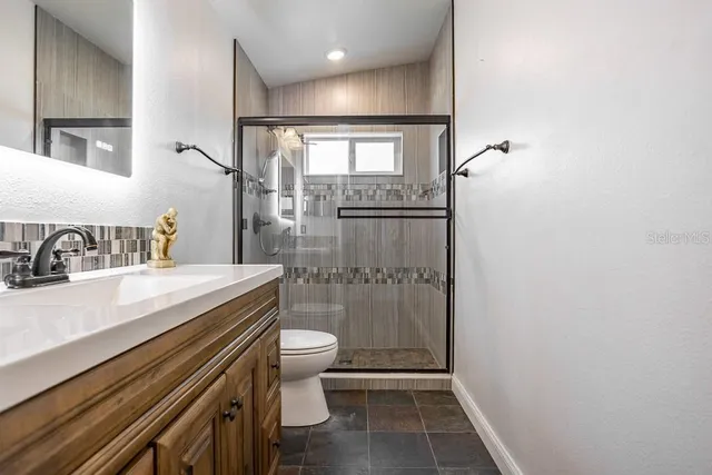 a bathroom with a sink toilet and shower