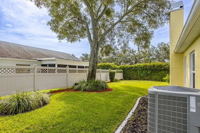 a view of an house with backyard space and balcony
