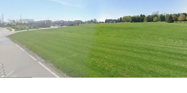 a view of a green field with clear sky