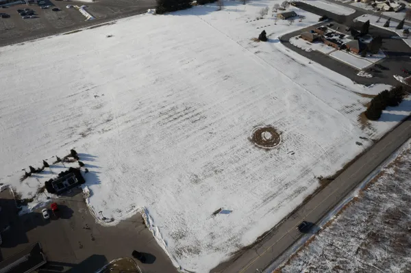 a bathroom with a granite countertop sink a mirror and shower