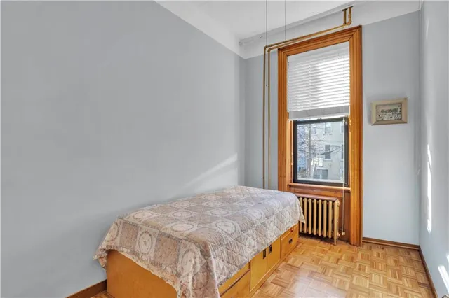 a living room with a black white checkered floor and a fireplace