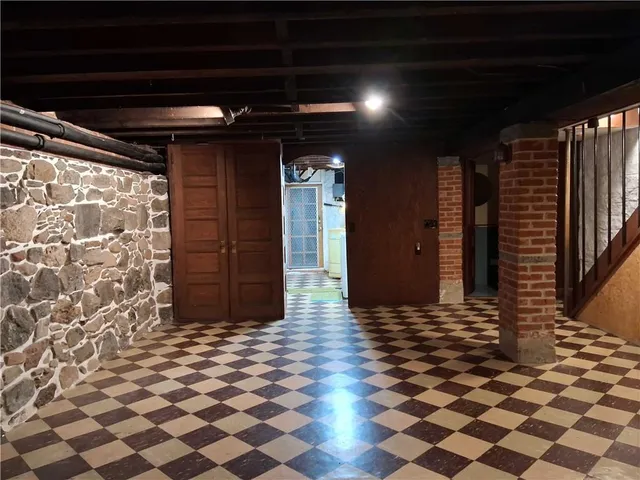 a view of a livingroom with a fireplace and window