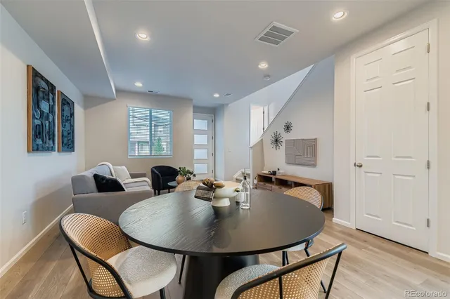 a dining room with furniture and wooden floor